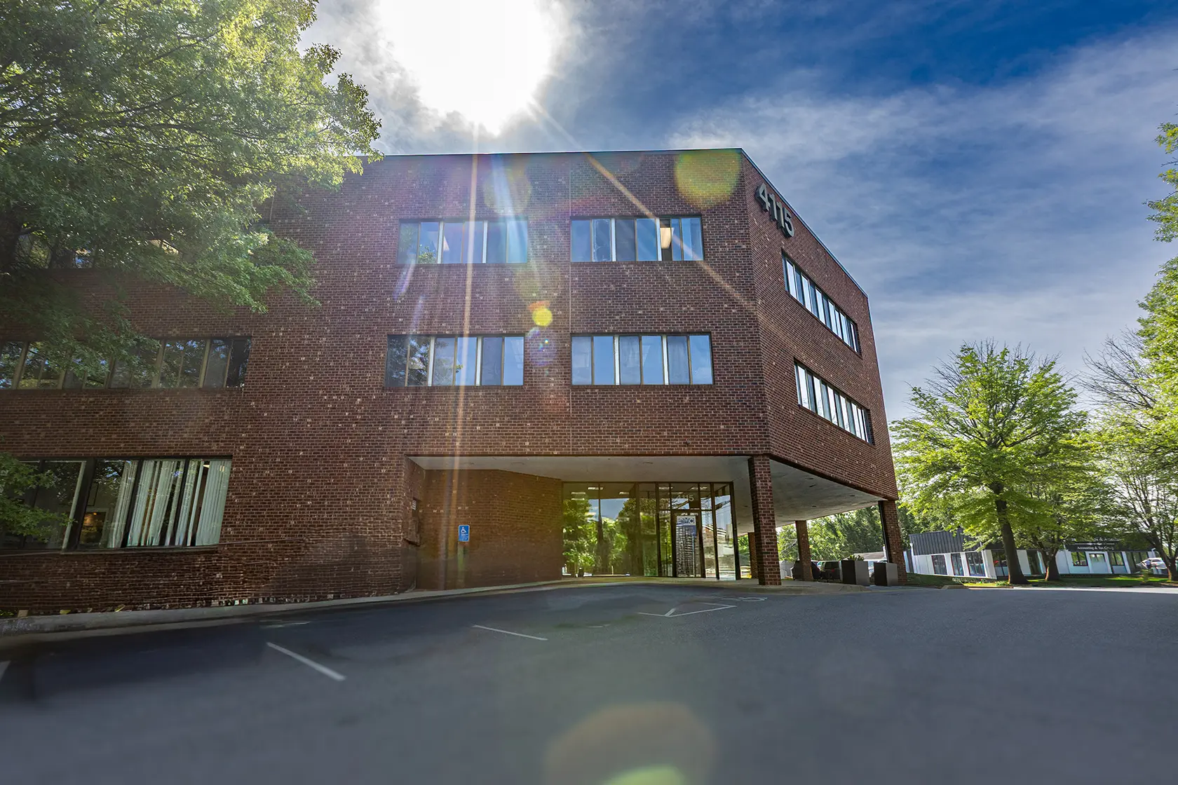 An image showing the exterior of a three-story brick building that has professional and medical office spaces for lease Annandale VA.