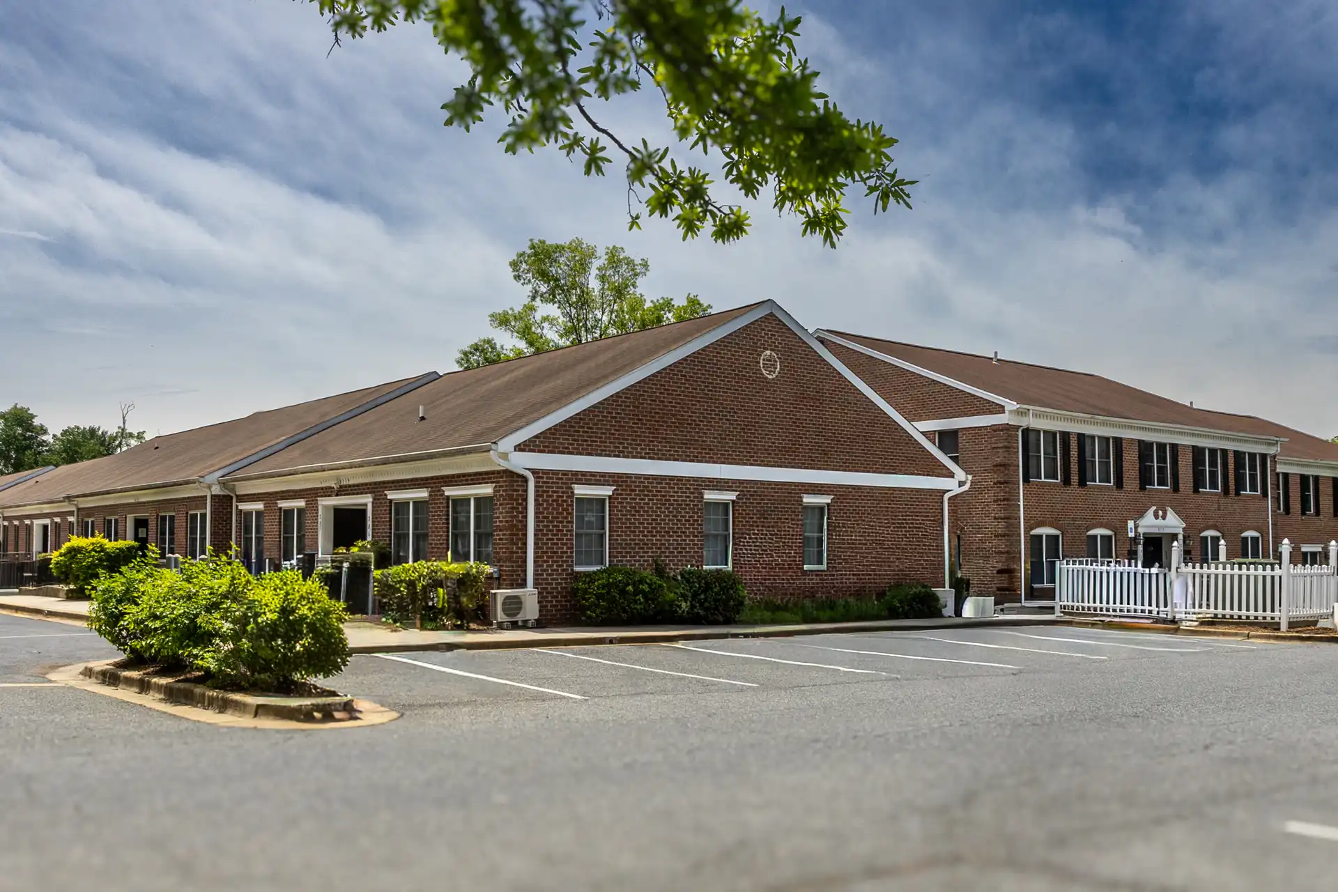 An exterior photo of a brick office building where there are move in ready office space​s for lease in Greenbelt Maryland.